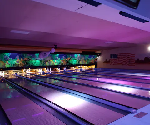 Bowlingbahn mit Lichtakzenten und sichtbarer Aktivität im Raum.