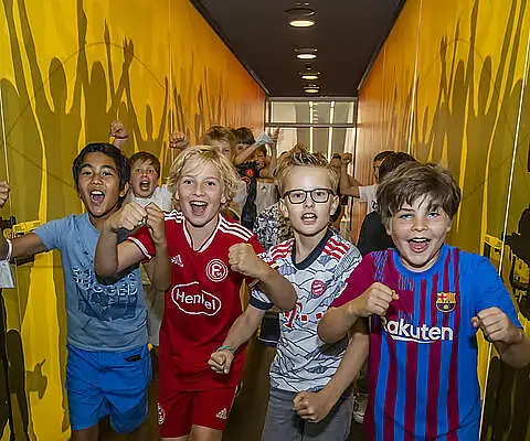 Kinder bewegen sich im Tunnel des Museums mit Fußballbezug.